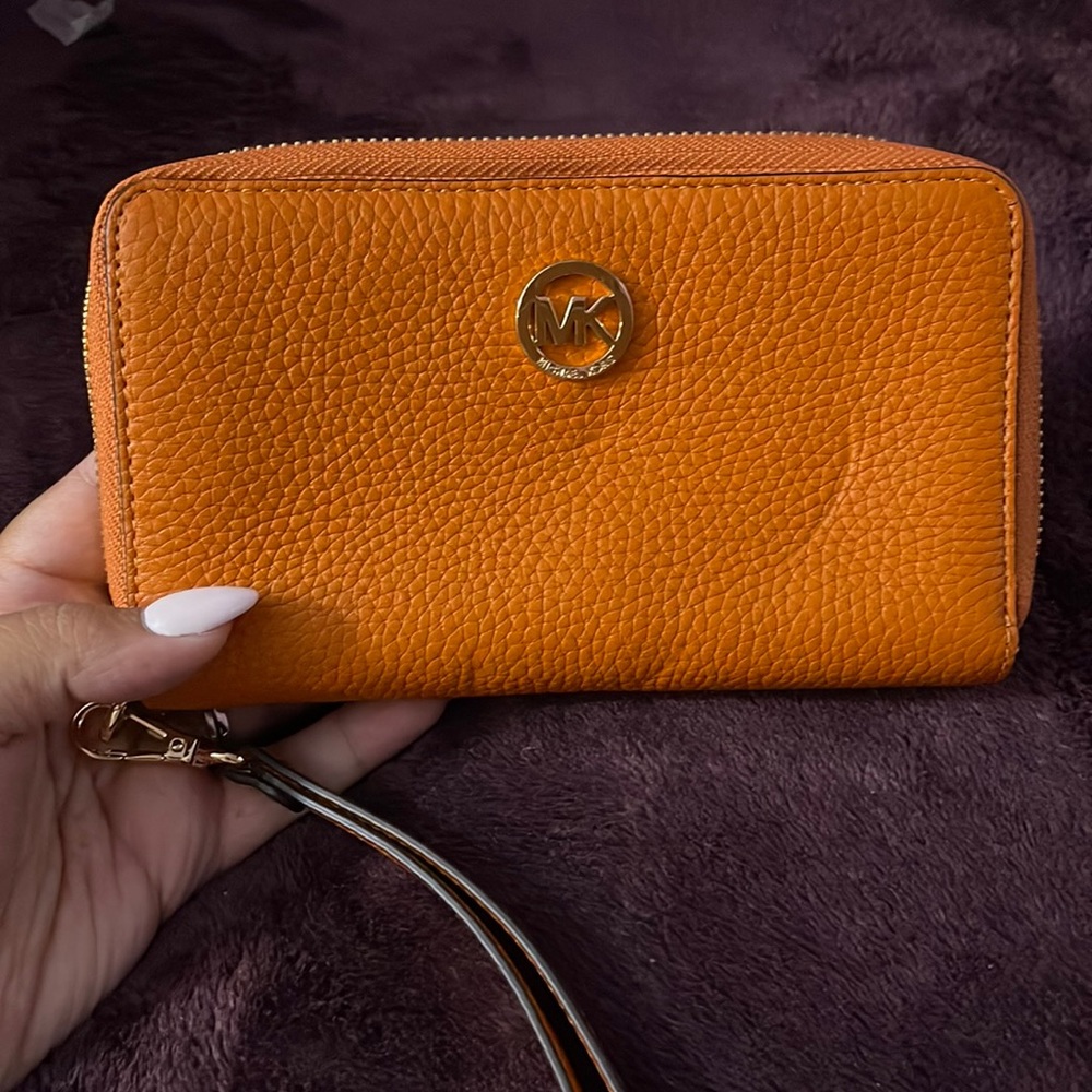 MICHAEL KORS Orange zip around wristlet